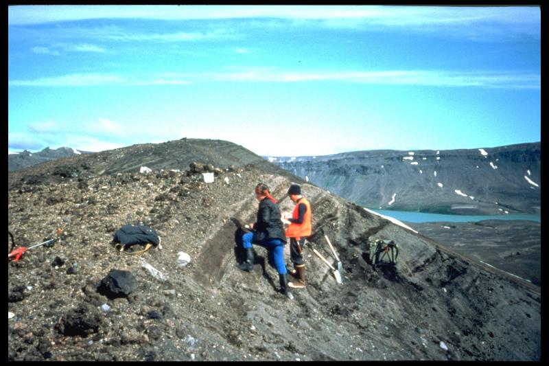 Tina Neal and Olga Braitseva (visiting Russian volcanologist) examine a section of surge deposits from Half Cone, Aniakchak Caldera