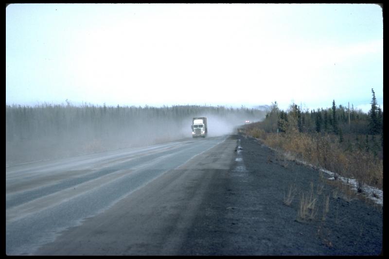 Vehicles stirring up ash on the Glenn Highway between Sheep Mountain and Glennallen.  The ash is from the Sept. 17, 1992 eruption of Crater Peak, Spurr Volcano.  
