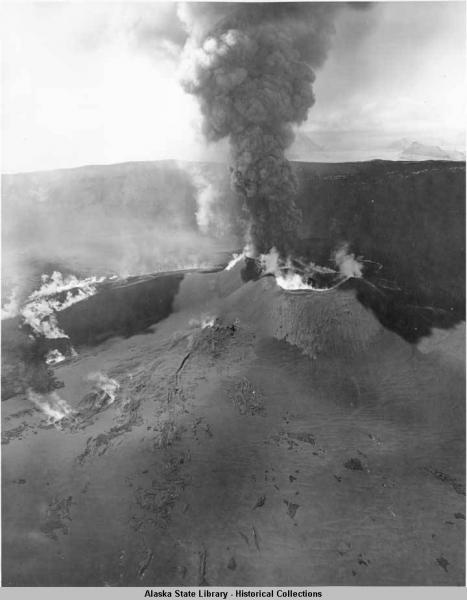 Aerial view of Cone A (Zoomie Crater) eruption at Okmok Volcano, Alaska.  Photograph from the Alaska State Library Historical Collection; ASL id is P338-0395; photographer's number is DHBR-2581.