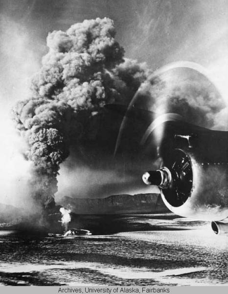 The active intracaldera cone of Mt. Veniaminof erupts ash during March, 1944.  According to the reverse of this photograph, this picture was taken from the nose of a naval air transport service plane by a pilot-photographic officer on a cargo-passenger flight from Seattle, WA to Alaska and the Aleutian Islands.
This photograph is from the San Francisco Call-Bulletin, Aleutian Islands Photographs, 1942-1948 Collection, accession number UAF-1970-11-108, Archives, Alaska and Polar Regions Collections, Rasmuson Library, University of Alaska Fairbanks. This photograph is also available at http://vilda.alaska.edu/u?/cdmg11,2530 .