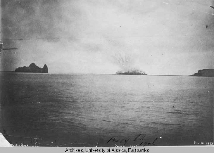 Bogoslof Island with prominent Castle Rock outcrop of stone (Old Bogoslof) and Fire Island (right) with Perry Island (Metcalf Cone) was a brief addition to the Aleutian Islands. This photograph is from the Perry Island Collection, accession number UAF-1999-222-2, Archives, Alaska and Polar Regions Collections, Rasmuson Library, University of Alaska Fairbanks. This photograph is also available at http://vilda.alaska.edu/u?/cdmg11,460 .