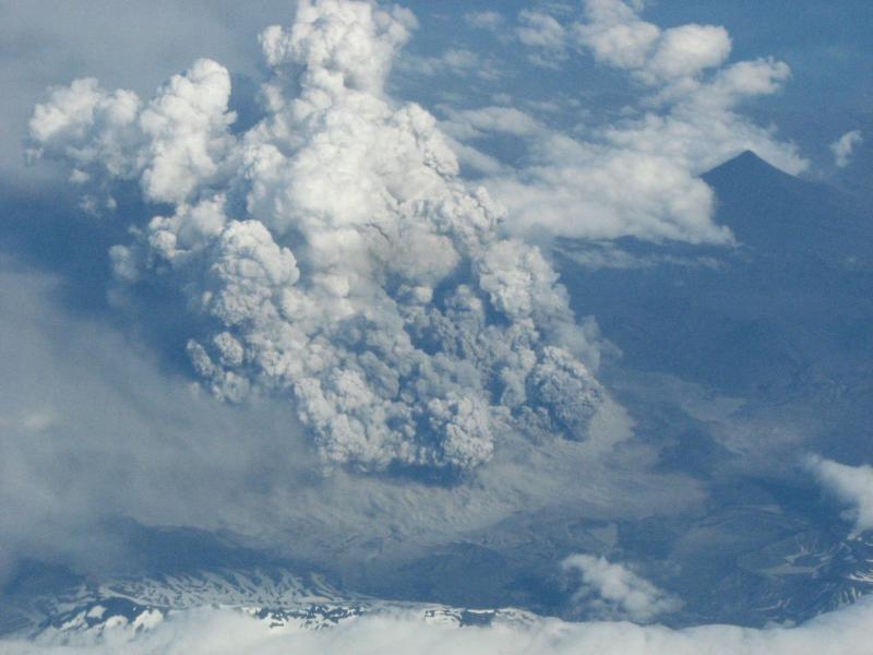 Taken from Alaska Airlines jet. Okmok from 37,000 ft looking south from about 15 miles to the north of it approx 1950 ADT. Estimated the tops of ash/vapor were at 20,000 ft.