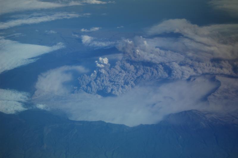 View of Okmok eruption, taken from NE bound Alaska Airlines flight at 35,000 ft above sea level on August 3, 2008 between 20:00 and 20:08. Plume tops estimated to ~ 7,000 ft above sea level using nearby Mount Vsevidof (elev. 7,051 ft / 2,149 m) for reference.