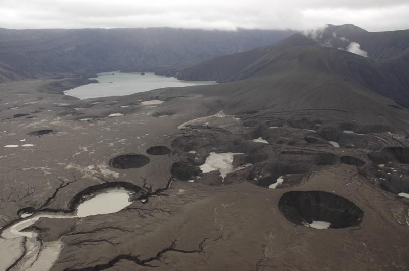 View to the ENE across the explosion crater field and ash-mantled 1958 lava flow surface that is no longer recognizable.  Modified old Cone D lake visible in the distance, and the new tephra cone with ~800 ft of vertical relief, is at the upper right, the Cone D summit beyond.  
