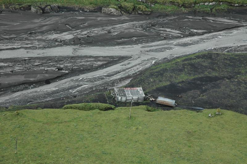 Cabin in Crater Creek; the quonset hut roof was moved to its present position by floodwaters at some point after the eruption.  We did not land here, but it appeared that a high-water/mud line was left several feet up the channel-facing cabin wall. A bridge that had previously crossed the creek here was gone.  Note large boulders in central channel several meters across, probably reworked pre-historic flood deposits from upstream.  