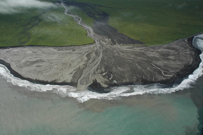 Crater Creek lahar deposit delta and sediment plume into the Bering Sea.  Shipwreck visible near the shoreline and left of the main central channel is 17 m long.