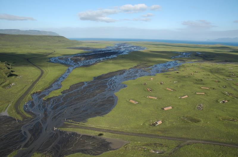 Aerial view of the Ft. Glenn ranch area showing the lahar pathway that destroyed the sauna (would have been just out of the photo at lower left, I think)and the road crossing heading towards Idak from the ranch.  These fans did not reach the sea, but spread out in the marshy basin here where cattle like to hang out and eat grass.  