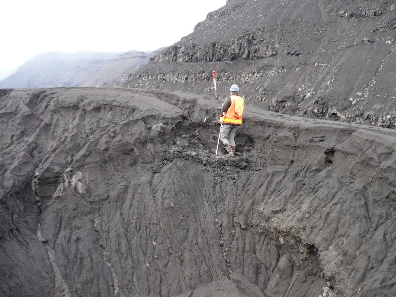 Jessica Larsen examining the tephra section in the Gates next to a GPS site that Max found by digging through several feet of ash for a couple of hours to find the benchmark.  The lowest layers here were saturated mud and would not hold a vertical face.  See Jess' video of the ground undulating like a waterbed with slight foot pressure beneath the helicopter skids.  