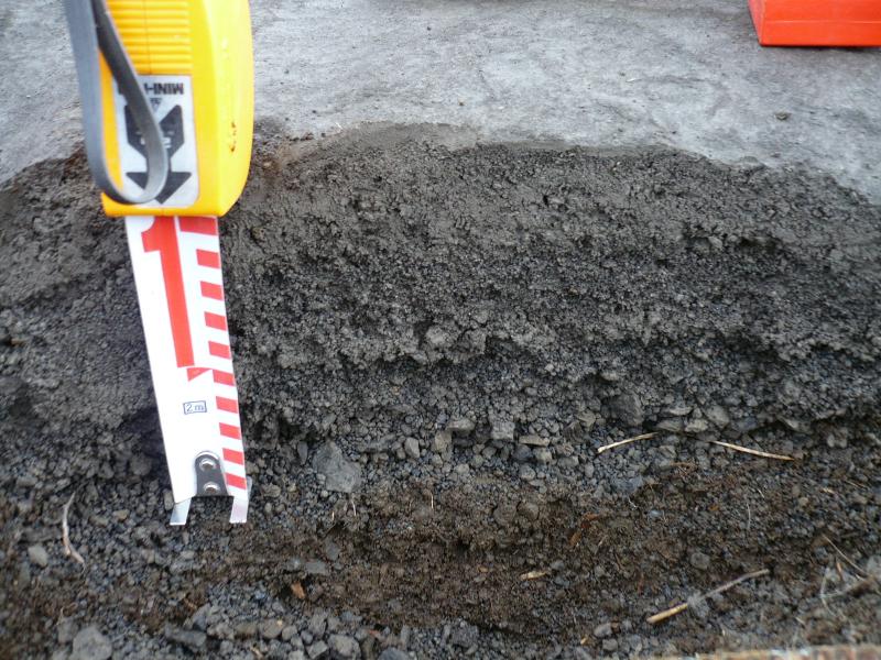 Tephra site 08JFLOK040 low elevation on the east flank not far from the base of Cape Idak and close to the axis of the July 12 plume. Prominent coarse ash and lapilli layers at base are July 12 fall units.  The lower coarse lapilli fall unit generally fines upward, is capped by a muddy fine ash, and then the upper July 12 fall is a coarse ash here.  Clasts are as large as 2 cm in the basal unit and 1 cm in the upper unit.  We measured max clast dimensions here and I took a 10x10 cm area sample to help with volume estimates.  