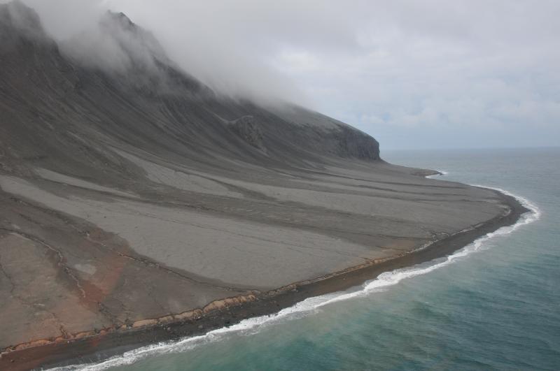 East flank of Kasatochi Island showing cover of fine ash and pyroclastic fan. Boulder lag in along shoreline are lithic components of the pyroclastic flow deposit. Cliff in background is former shoreline.