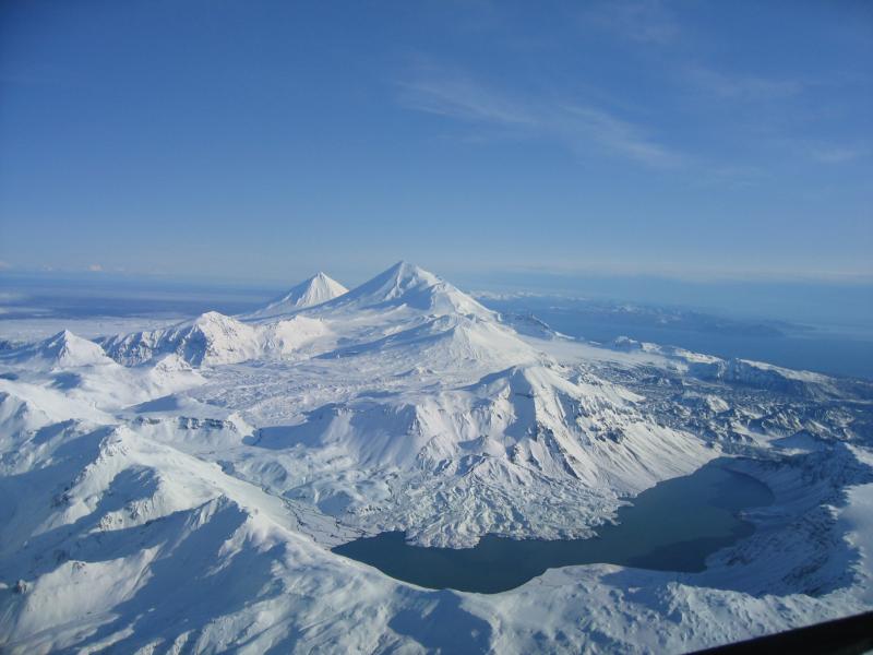 View, looking northeast, of 1,436-m (4,711 ft)-high Mount Emmons, a postcaldera stratovolcano within the Emmons Lake caldera on the Alaska Peninsula. The most recent of several caldera-forming eruptions at Emmons Lake occurred more than 10,000 years ago. No historical eruptions have occurred at the Emmons Lake caldera. In order going NE are Emmons Lake,  Mt Emmons, Hague, Double Crater, Little Pavlof, Pavlof, and Pavlof's Sister.	