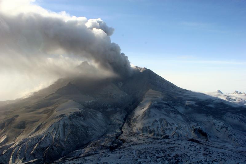 Redoubt volcano in continuous eruption on March 31, 2009.  Plume height is no more than 15,000 feet above sea level.  The small amount of ash in the plume is creating a haze layer down wind of the volcano and dustings of fine ash are falling out of the plume.  View is from the northwest. 