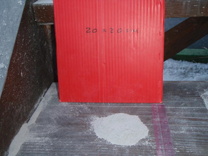 Ash fall in Homer, Alaska from Redoubt volcano on April 4, 2009 (explosive event that occurred at 5:55 am AKDT).  The red template was used to collect a measured-area sample.  The pile of gray ash is equal to 1 millimeter thick layer of ash fall in 20x20 cm area.