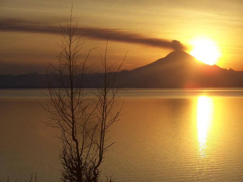 Redoubt, April 24, 2009. Sunset at Redoubt, viewed from Clam Gulch, Alaska. This photo was taken while the final lava dome of the 2009 eruption was still growing. Photo credit: Max Harris.
