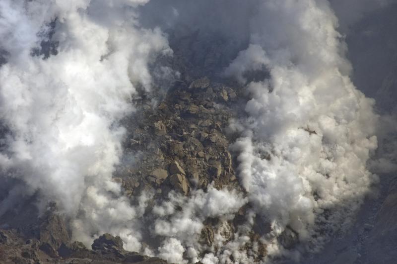 				Redoubt lava dome. View from over the west crater rim.  Ponded water along south margin is steaming.  Surface depression on top of dome noted on 4/28/09 appears to be filled (inflated).				