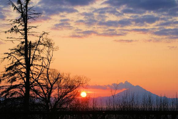 Beautiful sunset and Redoubt Volcano seen from Ninilchik, Alaska in May 2009.  Tomorrow marks the anniversary of the 1902 eruption of Redoubt, which made quite an impression on the few folks living in the area at that time.  From AVO's web page quoting the Alaska Dispatch, "On the date of the eruption the sky was darkened and at Sunrise, the snow was covered so thick with sand and ashes that it was impossible to do any sledding until a fresh fall of snow. At Hope, 12 miles distant [from Sunrise], the ashes were half an inch thick, and at Knik, on the opposite side of the Inlet was still deeper..... and the terrible force of the eruption can be imagined."