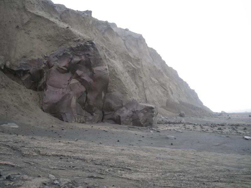 Former stack that stood offshore from east-northeast sea cliff and exhumed by erosion of Kasatochi 2008 deposits. Note deposits of fresh topples and slides from unconsolidated pyroclastic-flow deposits.