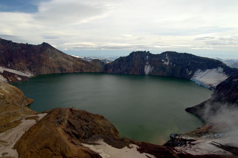 Katmai caldera, Katmai National Park and Preserve. The caldera formed on June 6-7, 1912, in response to withdrawal of magma that vented at Novarupta, 10 km west, at the head of the Valley of Ten Thousand Smokes. The caldera walls rise 250-800 m above the lake, which is 250 m deep and still filling. 