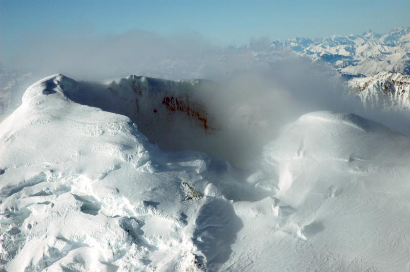 								View into the summit crater of Mount Spurr.  Steam plume rising from  active fumaroles on the north floor of the crater.				