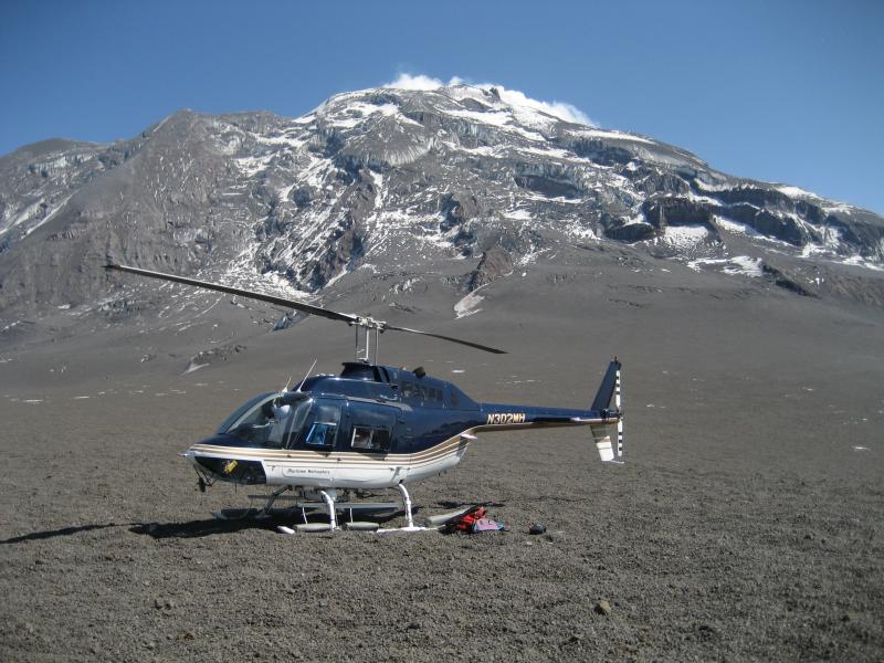 Helicopter landing site on the west side of Redoubt volcano, near the stations RDWB and RVBM.  Here pebbly clasts of pumice and fragmented dome rock litter the surface.  This layer, a few inches thick, overlies a permanent snowfield, and was deposited by the explosive event on April 4th 2009.  **AVO research technician Max Kaufman took these images during 3 days of campaign GPS work on and around Redoubt volcano: June 6,8,10 2009.