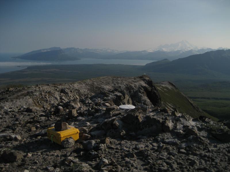 A view to the south of Tuxedni Bay and Iliamna volcano, from the Redoubt GPS site POLL, above Polly Creek.   **AVO research technician Max Kaufman took these images during 3 days of campaign GPS work on and around Redoubt volcano: June 6,8,10 2009.