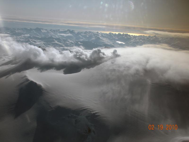 Oblique airphoto showing steaming from the summit of Makushin Volcano.