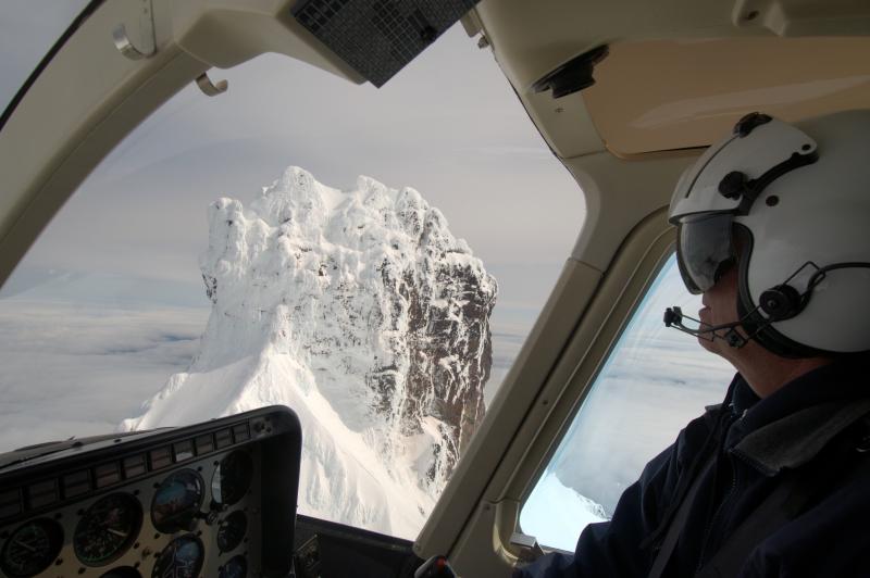 																							Maritime Helicopter Pilot Bill Springer with the summit of Isanotski in the background.