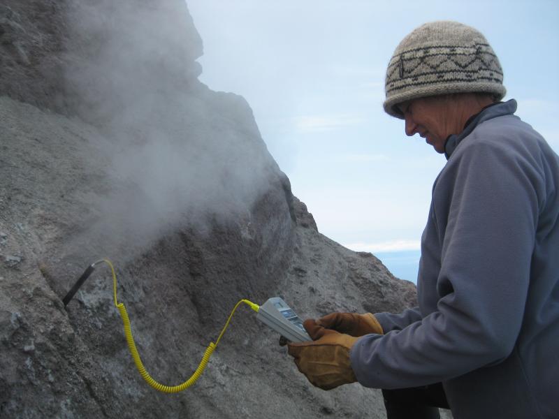 Deb Bergfeld measures the temperature of a gas vent (AUG10_02) on Augustine volcano.