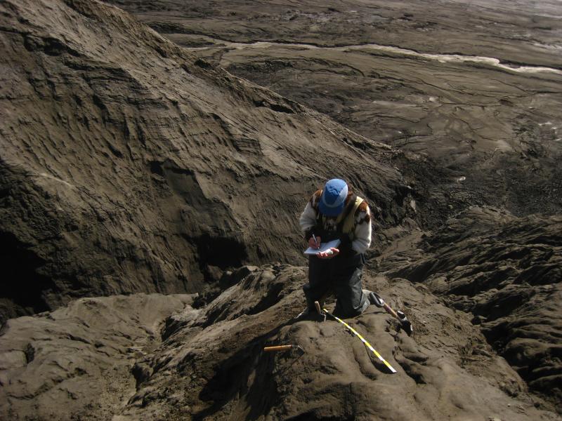 Dr. Michael Ort (Northern Arizona University) working on an outcrop of 2008 Okmok eruption deposits. Michael is located on the southern flanks of Cone D in this photo.