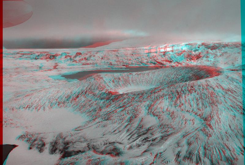 Anaglyph (3D) image of aerial images taken within Okmok Caldera. To view this image, please use red-blue glasses with left eye red. Note still warm areas on flank of Cone D exposed in lava cliffs.	Thank you to Burke Mees, photographer, and Peter Lipschutz, for creating the 3D image.	