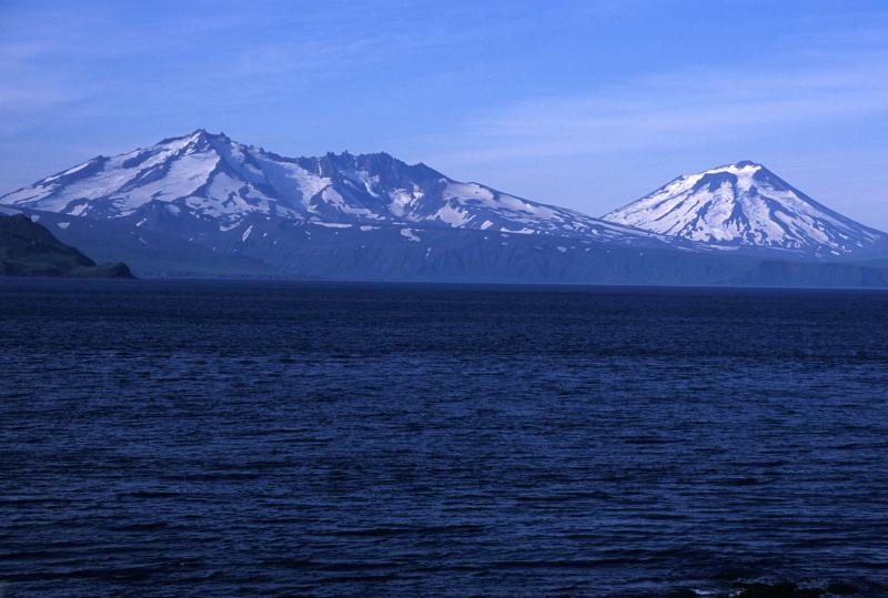 Vsevidof (on the right side of the image) and Rechesnoi, viewed from the northeast coast of Umnak Island.