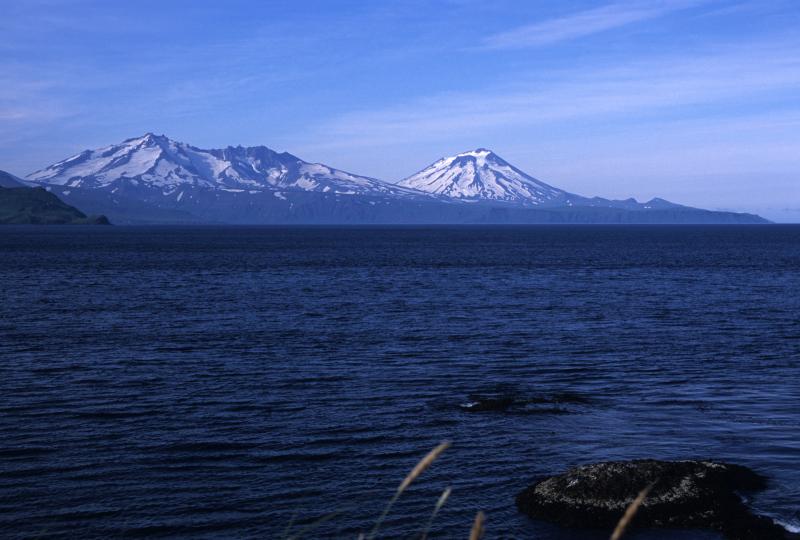 Vsevidof (on the right side of the image) and Recheshnoi, viewed from the northeast coast of Umnak Island.