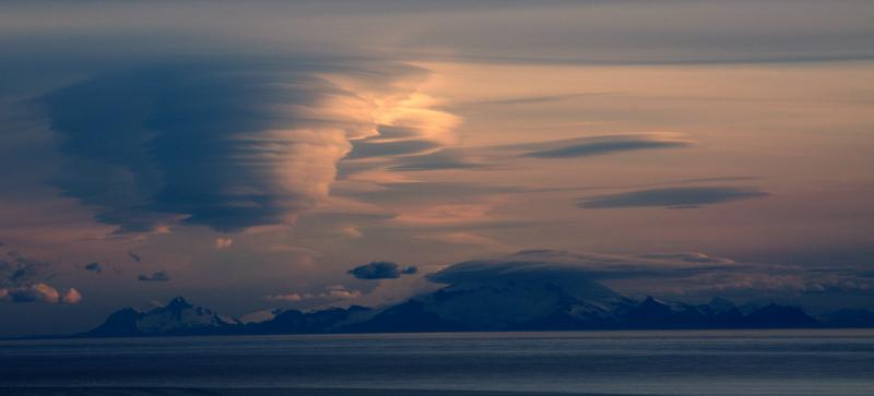 Lenticular clouds build over Douglas volcano at sunset.