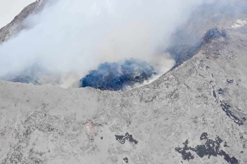 Aerial photograph of Cleveland&#039;s August 2011 lava and summit crater. This lava dome was extruded sometime after July 7 when the last clear view of the summit area did not show this feature. The formation of the lava dome is consistent with thermal anomalies observed in satellite imagery since July 19, 2011. This dome is approximately 60 m in diameter in a 200m-wide crater.
Photograph courtesy of Dave Withrow, National Oceanic and Atmospheric Administration.
