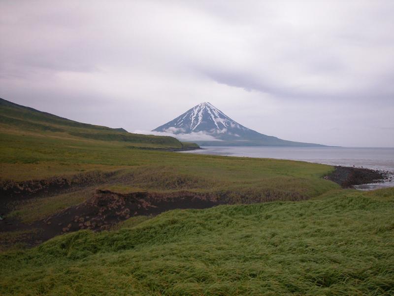 Photo taken from Applegate Cove on Chuginadak Island in July of 2002; this image shows the southeast flank and summit of Mt. Carlisle volcano. A lava flow from Mt. Cleveland volcano is in the middle left of the image. 