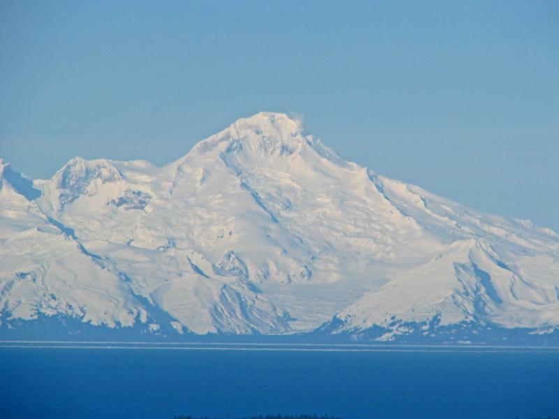 View of Iliamna on the morning of March 9, 2012, from Diamond Ridge on the Kenai Peninsula. Iliamna's prominent and long-lived fumaroles are visible. Photograph courtesy of Dennis Anderson, Night Trax Photography.