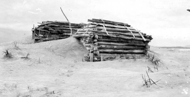 Photograph of ash covering a home in Katmai Village, after the 1912 eruption of Novarupta. Photo taken by G.C. Martin, U.S. Geological Survey. This image is image mgc00747 in the U.S.G.S. photolibrary.