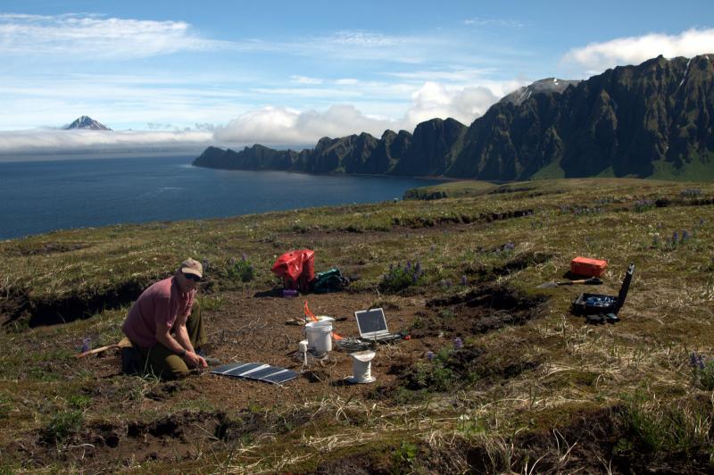 AVO scientist in charge John Power installs a broadband station above Hot Springs Bay on Akutan Island.