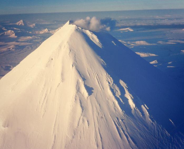 Beautiful Shishaldin Volcano on December 31, 2012. Shishaldin is often steaming, as visible in this photograph. Photograph courtesy of Robert Yatteau, U.S. Coast Guard.