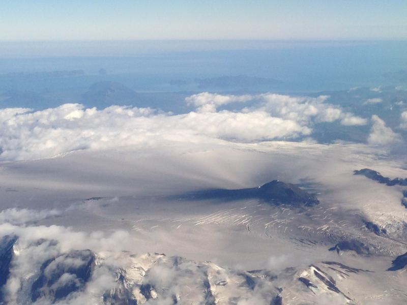 Aerial view of Veniaminof during the 2013 eruption.  Radiating spokes of ash fall visible on the summit caldera glacier.  