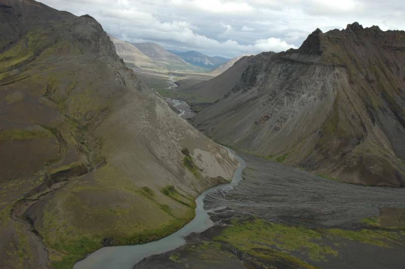 View east through The Gates of Aniakchak.  Image taken following the 2010 breakout flood of the large maar crater located along the east wall of the caldera.  The outwash fan was swept and up to 1.5 m of coarse sand and gravel deposited.  The Aniakchak River channel and flood plain were affected for at least 20 km downstream.  Compare with image 10534.