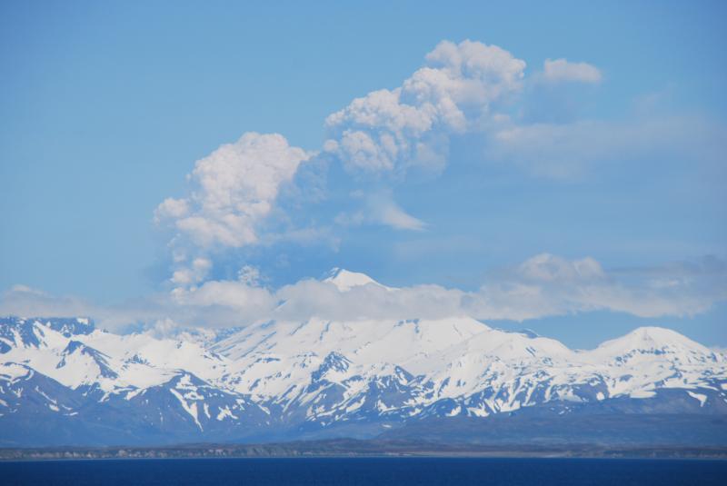 Eruption of Pavlof Volcano, June 2, 2014.  Image copyright Christopher Diaz at northernXposed Photography.  This image shows steam and ash rising from pyroclastic flow(s) that have descended the north flank and intermixed with glacier ice.