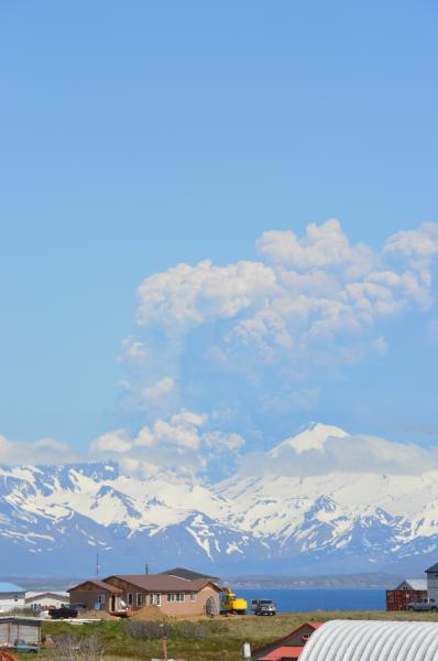 Eruption of Pavlof Volcano as viewed from Cold Bay, located about 37 miles southwest of the volcano.  In this image, ash and steam can be seen rising from pyroclastic flow(s), generated by collapse of lava spatter accumulated around the summit vent, that intermixes with glacier ice on the north flank.