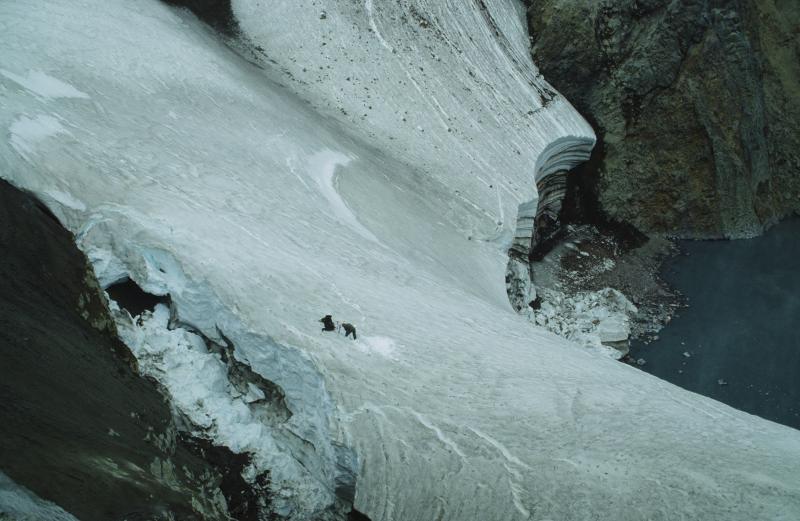 AVO geologist Game McGimsey setting an anchor system to rappel down to the warm, acidic lake within Crater Peak vent of Mount Spurr.  The object was to collect water samples, measure temperature and pH, and make observations of the numerous upwellings.  The first of 3 eruptions occurred on June 27, 1992.