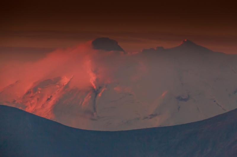 Fumarolic emission from Chiginagak volcano on the Alaska Peninsula.  This is a long-lived side of steam and volcanic gas emission, but in late September 2014 there was an apparent increase in temperature and perhaps flux from the fumarole.  This resulted in a more robust cloud, visible from space by satellite, detectable quantities of sulphur dioxide, and what appears to be a melt channel in the surrounding glacier. No regional earthquakes have been detected, although AVO does not maintain any seismic stations near this volcano and very small events may have gone unnoticed.  