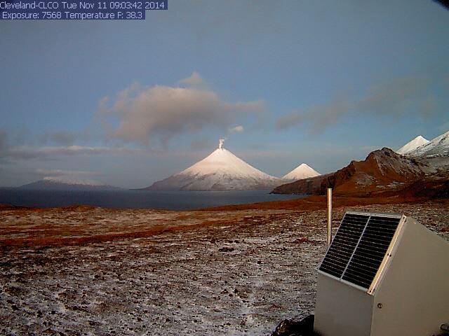 CLCO web camera shows a snow-covered Cleveland volcano, with typical small steam plume. Snow-covered Carlisle (right), and a dusting of new snow for the flanks of Tana (where CLCO is located).