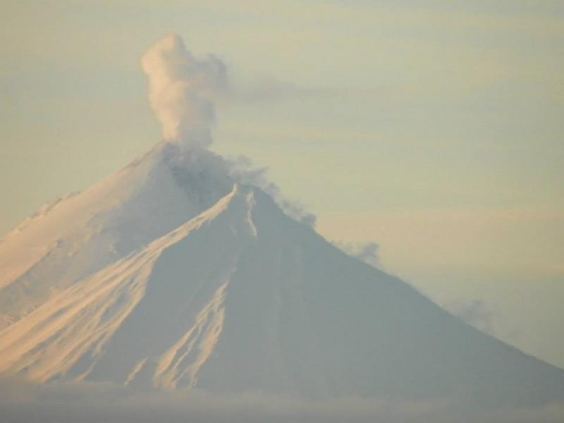 Pavlof volcano with steam rising from the 2014 vent region, as viewed from Nelson Lagoon, December 5, 2014. Pavlof Sister is the lower peak in front of Pavlof. Photo courtesy of Merle Brandell.