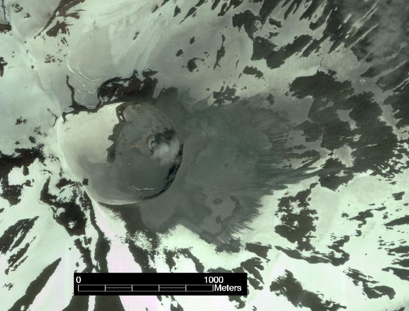 True color Ikonos satellite image of the summit crater of Korovin Volcano. This image was collected on July 4, 2004 and shows a grey-colored deposit of volcanic ash extending 1 km to the east of the crater. A small lake is frequently observed in the summit crater and flowage features in the deposit suggest that event that produced the ash deposit contained abundant water. 