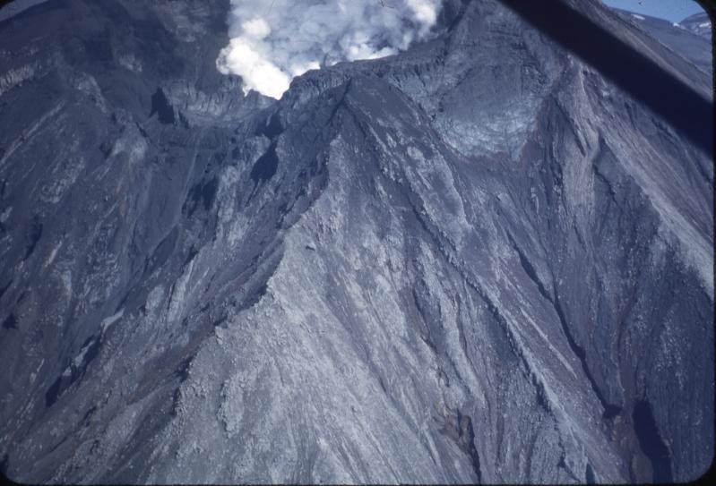 Steam plume rising from the Crater Peak vent on Mt. Spurr volcano.  Photo taken on morning of July 11, 1953, following the July 9 eruption that dropped 6 mm of ash on Anchorage.  The volcano is heavily coated in ash.