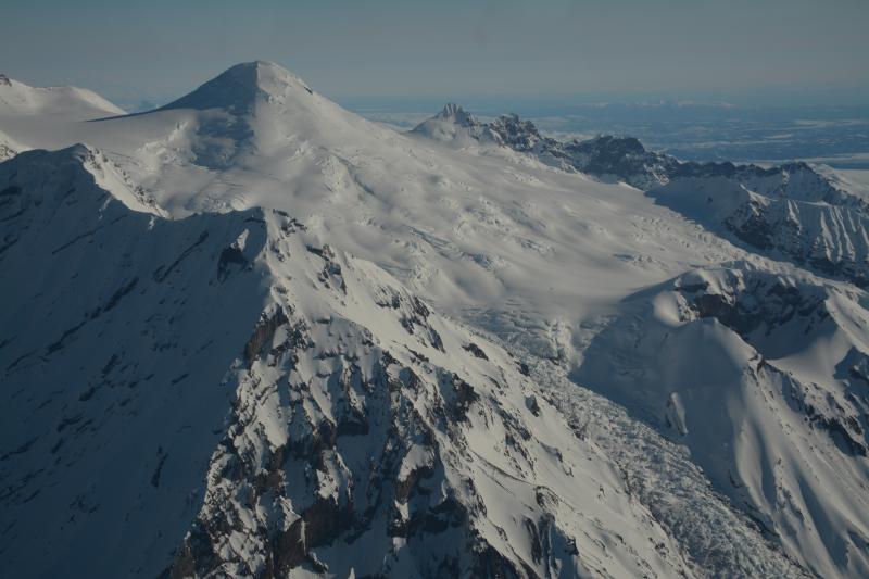 View form the southwest of Mt. Spurr volcano summit (upper left) and the historically active satellite vent, Crater Peak (right center).